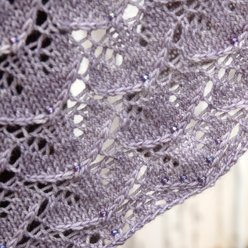 A close up of a beaded shawl